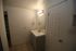 Bright and modern bathroom featuring a sleek vanity with under-sink storage, elegant tile flooring, and contemporary lighting.