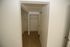 Spacious walk-in closet with elegant wood flooring and ample shelving space.