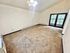 Bright living space with plush carpeting and elegant French doors, offering a cozy and inviting atmosphere.