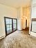 Inviting living space with plush carpet, elegant French doors, and warm ambient lighting.