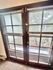 Charming glass French doors with elegant blinds opening to a private balcony surrounded by lush greenery.
