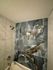 Elegant bathroom with luxurious marble-patterned tiles and modern fixtures.