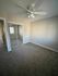 Bright and airy bedroom with plush carpeting, mirrored closet doors, and ceiling fan, offering a comfortable living space.