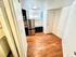 Inviting kitchen space with sleek stainless steel appliances, abundant natural light, and elegant wood flooring.