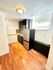 Chic modern kitchen with stylish backsplash, sleek cabinetry, and natural light highlighting the hardwood floors.