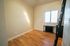 Bright and cozy room with stylish wooden flooring and a large window inviting natural light.