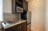 Chic kitchenette with modern appliances and stylish tile backsplash, perfect for efficient cooking.