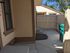 Charming enclosed outdoor space with fresh concrete patio, perfect for relaxation and privacy.