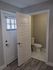 Inviting entryway leading to a cozy bathroom with elegant marble tile flooring.