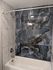 Luxurious bathroom featuring elegant marble tiles with an exquisite black and white pattern, complemented by a modern bathtub and chrome fixtures.
