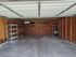 Spacious garage with ample storage shelves and versatile potential for organization.