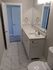 Elegant bathroom featuring modern fixtures, sleek countertop, and marble tile flooring.
