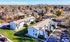 Charming apartment complex with lush greenery, situated in a peaceful neighborhood, offering stunning city skyline views.