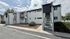 Charming two-story apartment building with modern exterior, featuring unique architectural design and private entrance.