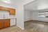 Bright, modern open-concept kitchen and living area with sleek wooden cabinetry and spacious light-filled interiors.