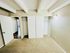 Bright bedroom with plush carpet, sliding closet doors, and exposed ceiling beams, offering a cozy and inviting space.