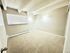 Bright and inviting empty bedroom with soft carpet, large window, and modern lighting perfect for customization.