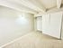 Bright and airy bedroom featuring soft carpet flooring, modern light fixture, and spacious closet with sliding doors.
