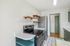 Modern kitchen with sleek stainless steel appliances, stylish open wooden shelves, and elegant tile flooring.