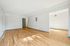 Bright, spacious living space with elegant hardwood flooring and modern design, perfect for creating your dream home.