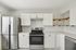 Modern kitchen with sleek stainless steel appliances, white cabinetry, and open wooden shelving.