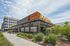 Chic urban restaurant with modern architecture surrounded by green landscaping, perfect for vibrant city dining.