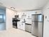 Sleek modern kitchen featuring stainless steel appliances, elegant white cabinetry, and clean minimalistic design.