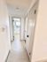 Bright and inviting hallway with modern doors in a contemporary apartment, featuring sleek finishes and light wood flooring.