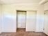 Bright and spacious closet with sliding doors, showcasing ample storage space and modern design.