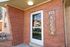 Inviting entrance with classic red brick design at Lucca apartment complex.