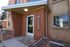 Charming red brick apartment entrance with modern design at 815 LUCCA, accented by a sleek canopy and inviting walkway.