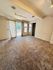 Spacious and inviting room with plush carpeting, modern track lighting, and large windows letting in natural light.