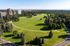 Scenic aerial view of a lush green park surrounded by towering buildings and extensive greenery, ideal for rejuvenating urban living.