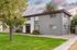 Inviting two-story apartment building with modern design, set amidst lush greenery and a serene pathway.