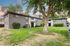 Charming apartment building surrounded by lush greenery and towering trees, offering a serene residential environment.