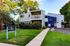 Charming Crescent Apartments exterior showcasing modern architecture with lush greenery and a welcoming entrance.