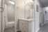 Bright and modern bathroom with sleek fixtures and spacious vanity, highlighting elegant design and style.