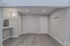 Modern entryway featuring sleek wood flooring, elegant lighting, and a stylish coat rack, exuding a welcoming and contemporary vibe.