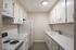 Bright and modern kitchen with sleek white cabinetry, ample counter space, and contemporary appliances.