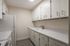 Sleek and modern galley kitchen with ample white cabinetry and spacious countertops, perfect for culinary adventures.