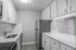 Modern kitchen with sleek white cabinetry, elegant countertops, and stainless steel appliances.