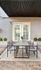 Chic outdoor patio with a sleek dining set under a modern awning, perfect for stylish entertaining.