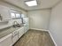Bright and modern kitchen with sleek cabinetry, stainless steel sink, and contemporary appliances.