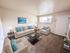 Bright and welcoming living room with cozy beige sofas, elegant decor, and natural light highlighting the open space.
