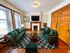 Inviting living room featuring elegant wood accents, plush green sofas, and a cozy fireplace, perfect for relaxation and gatherings.