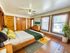 Inviting bedroom with natural light, featuring wooden accents, cozy bedding, and vibrant decor.