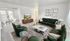 Elegant living room with plush green velvet sofas, a chic coffee table, and wall art; adjacent dining area with large windows letting in abundant natural light.