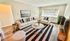 Inviting living room with sleek modern furniture, natural light, and stylish decor, perfect for relaxation and entertainment.
