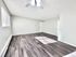 Bright, spacious living room with modern laminate flooring and abundant natural light.