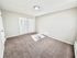 Bright and spacious bedroom with plush carpeting and ample closet space, perfect for a cozy retreat.